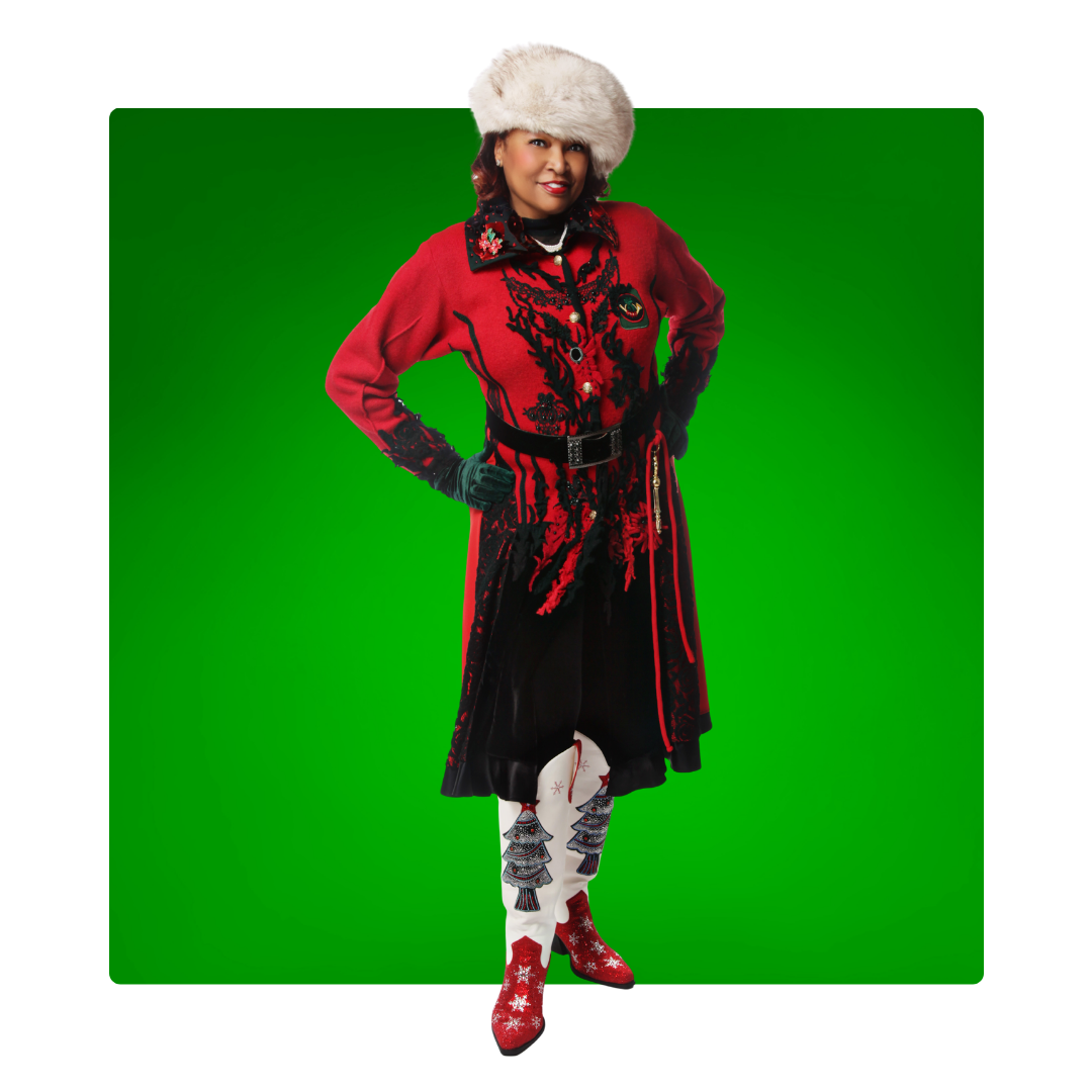 Ms. Santa Nashville wearing a red and black Christmas outfit with a white hat on a green background