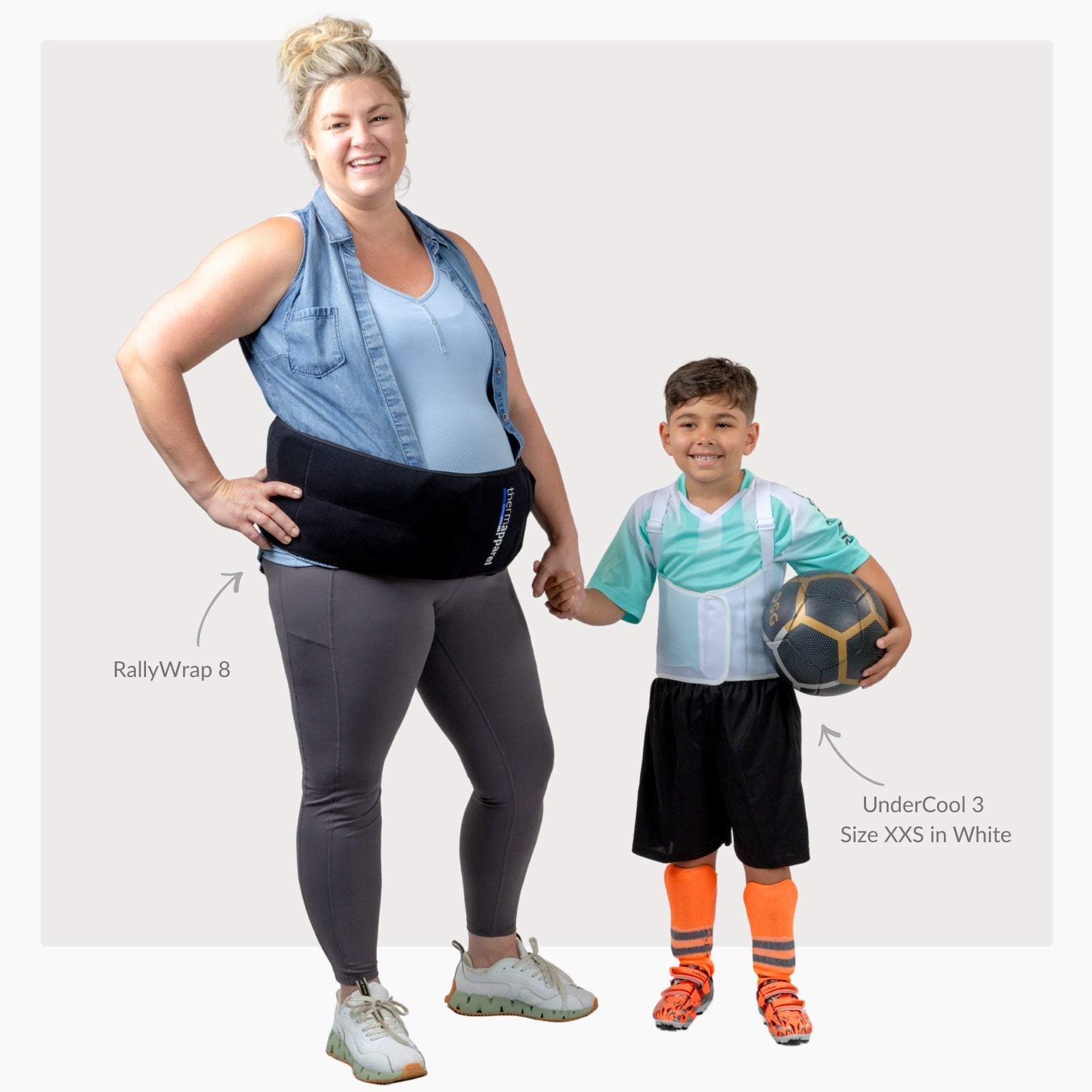 Pregnant woman wearing a ThermApparel RallyWrap holding the hand of a child wearing athletic clothing with a ThermApparel UnderCool XXS over a soccer shirt on a white background