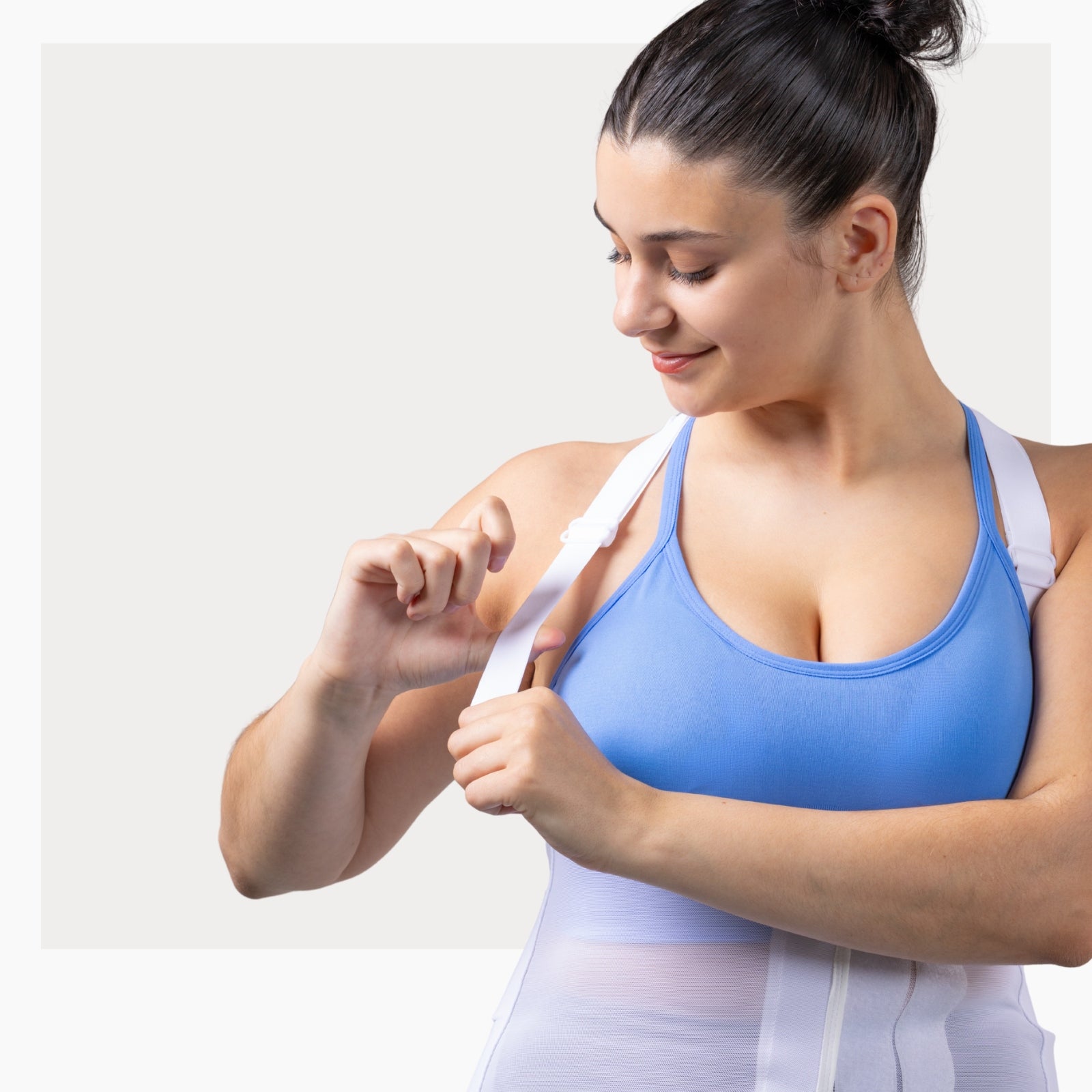 Woman wearing a white ThermApparel UnderCool 3 Cooling Vest demonstrating how the arm strap works
