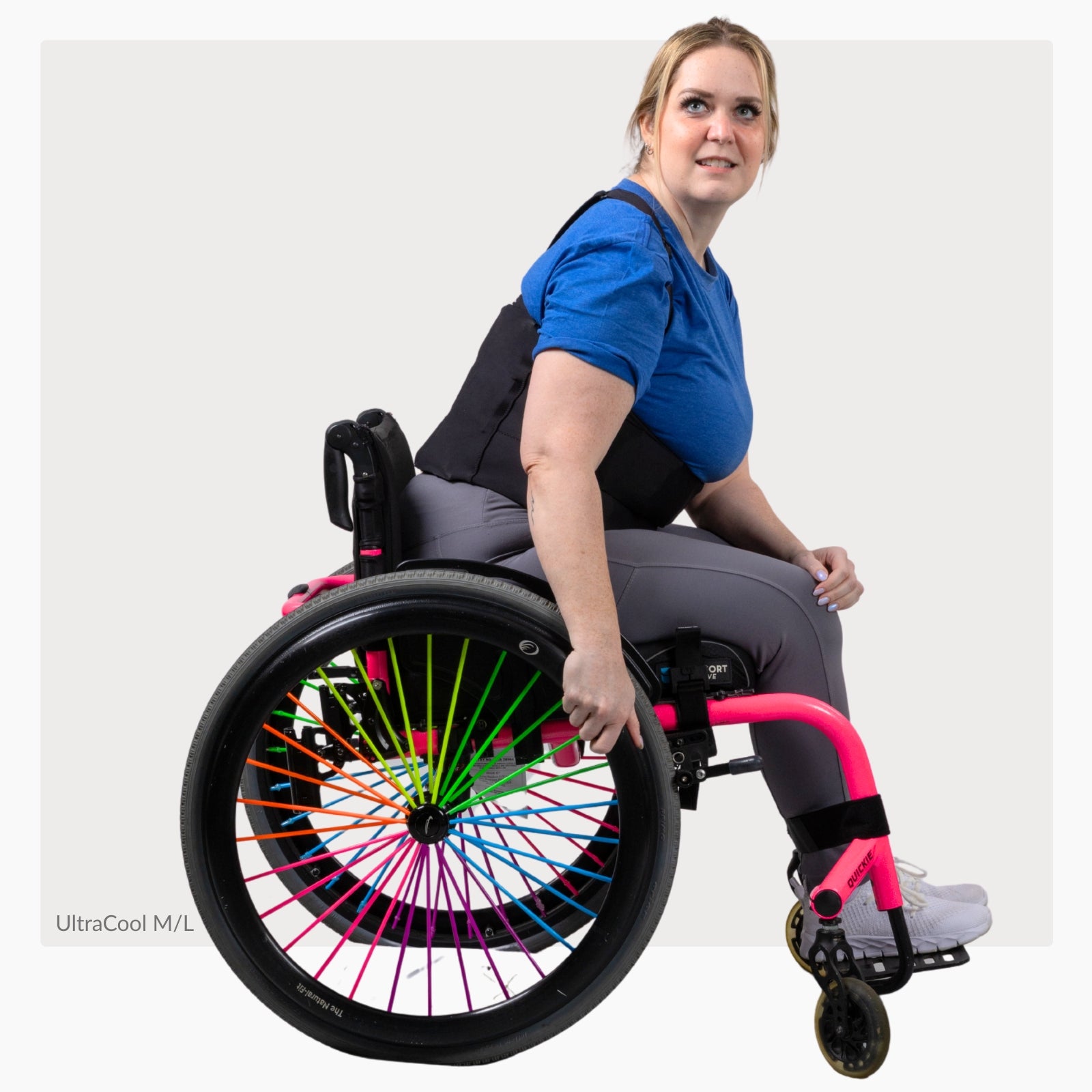 Woman in a wheelchair with colorful wheel design wearing a ThermApparel UltraCool M/L on a white background